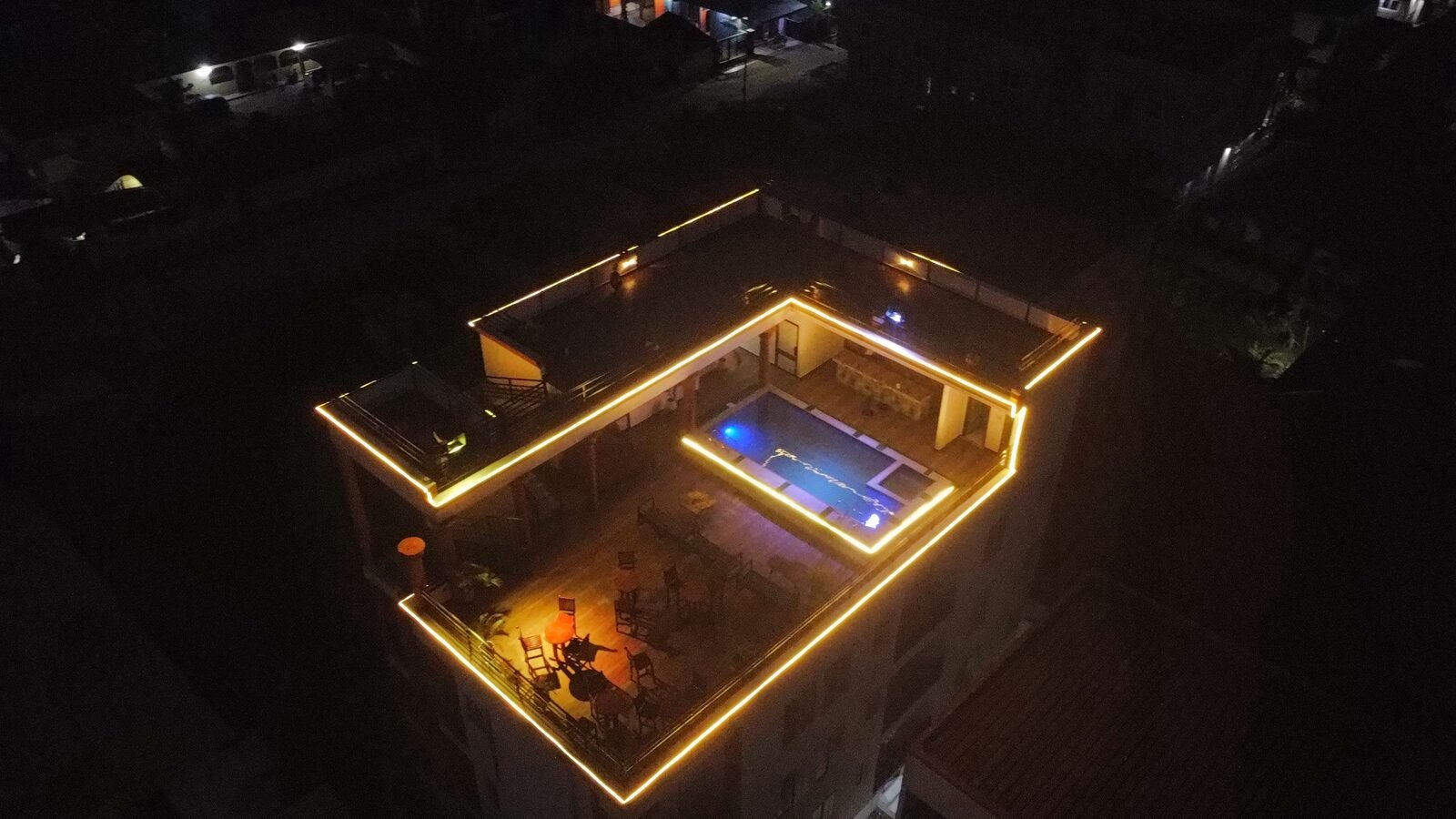 Skice rooftop pool and lounge lit up at night